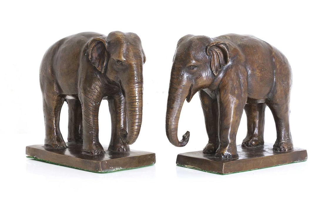 A pair of bronze bookends, 20th century: A pair of bronze bookends, 20th century Modelled as elephants on a rectangular plinth base 21cm wide, 10.6cm deep, 20cm high2