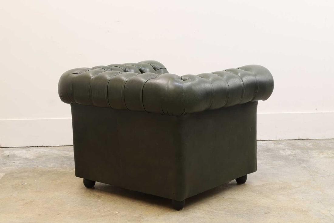 A green leather Chesterfield style armchair, 20th century, - 2