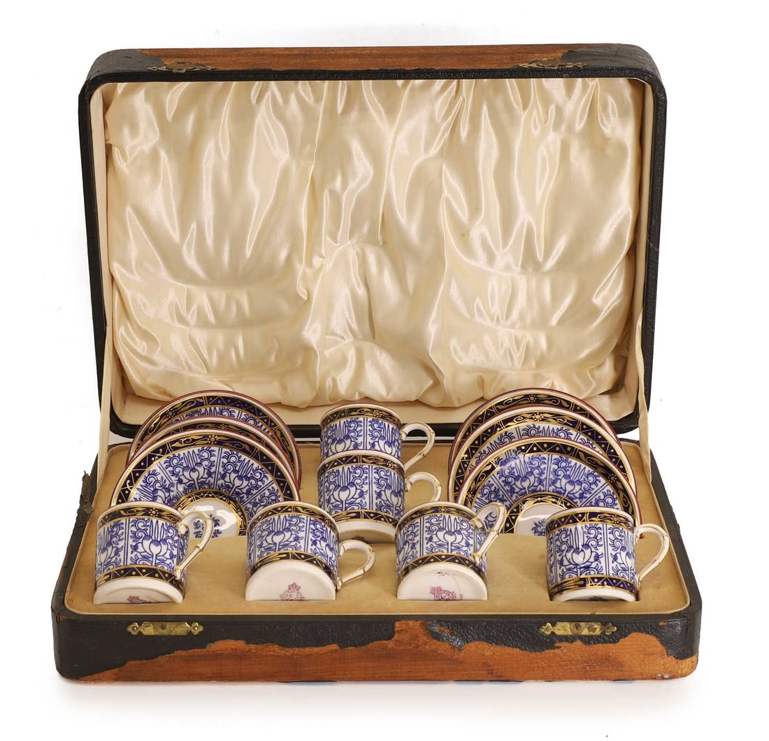 A Royal Worcester coffee service, 19th century: A Royal Worcester coffee service, 19th century Royal lily pattern comprising of six teacups and saucers, the teacups with faux bamboo style handles, cased Saucers, 11cm wide; Teacups, 5.3cm high12Con