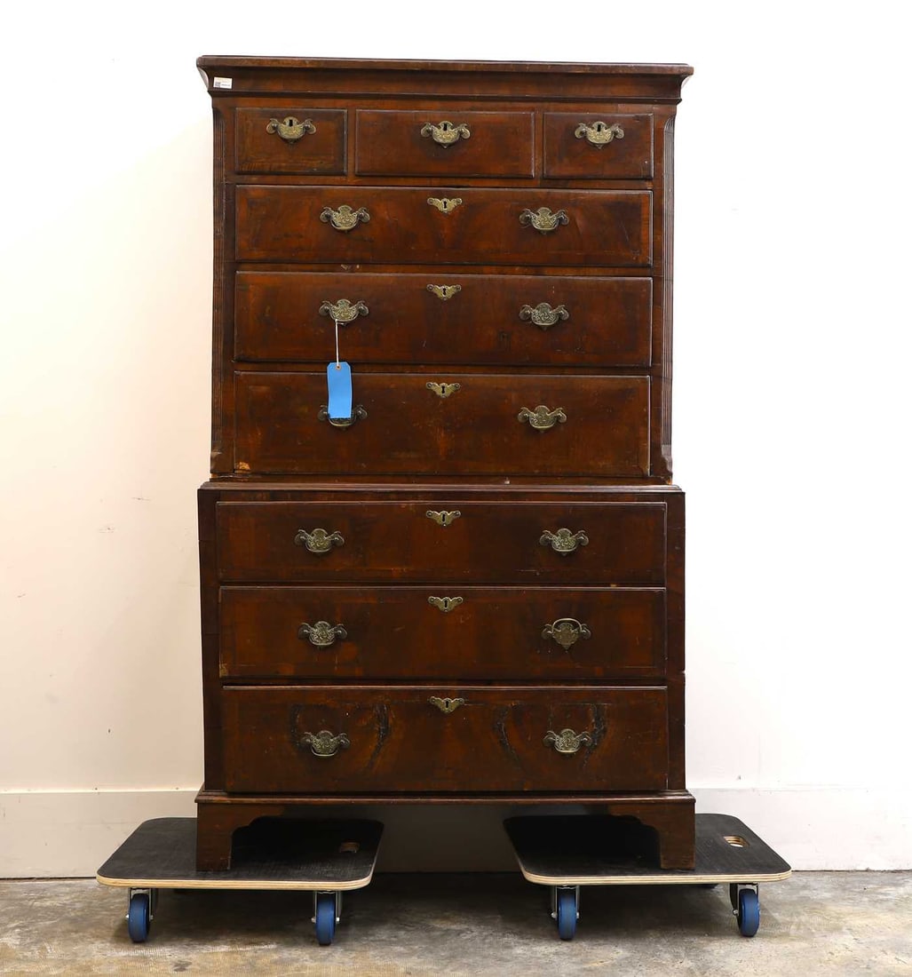 A George III walnut and mahogany chest on chest Late 18th century / early 19th century: A George III walnut and mahogany chest on chest Late 18th century / early 19th century In two sections, the top with chamfered and fluted corners, raised on bracket feet 105cm wide, 51cm deep,&#