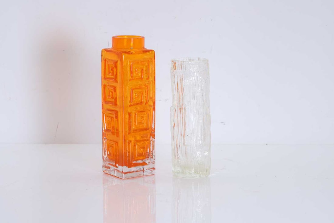 Whitefriars tangerine orange bark cylindrical vase, Of modern manufacture,: Whitefriars tangerine orange bark cylindrical vase, Of modern manufacture, designed by Georffrey Baxter, together with a clear glass example Whitefriars, 20cm high; Clear vase, 17cm high 2