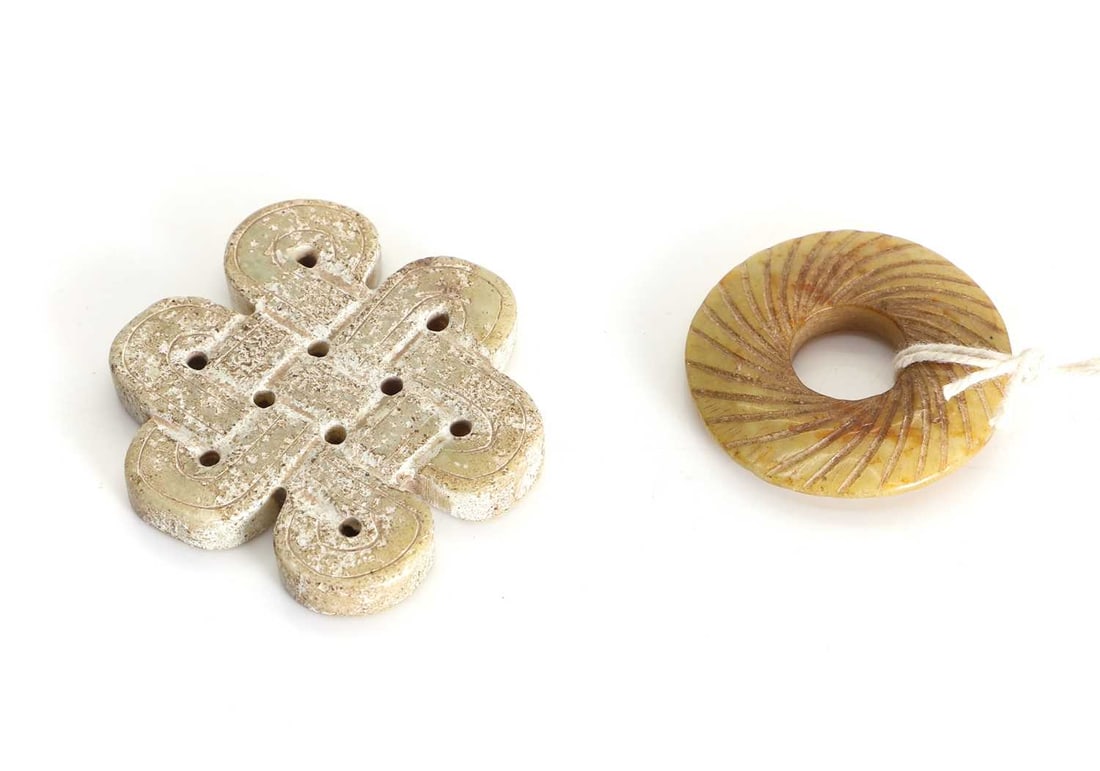 Two jade pendants, 20th century / 21st century,: Two jade pendants, 20th century / 21st century, The first design and the endless knot, and the second of circular form with grooved design Knot, 5.7cm wide; Circular, 3.7cm wide 2 Condition