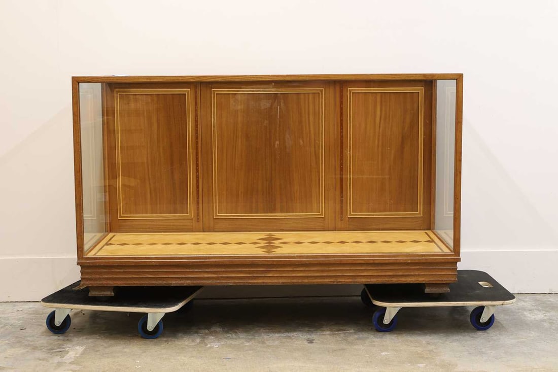 A walnut display case, 20th century,: A walnut display case, 20th century, Lined with a paquetry floor and with glazed sides and front, raised on bracket feet, with castors 153cm wide, 61cm deep, 92cm high
