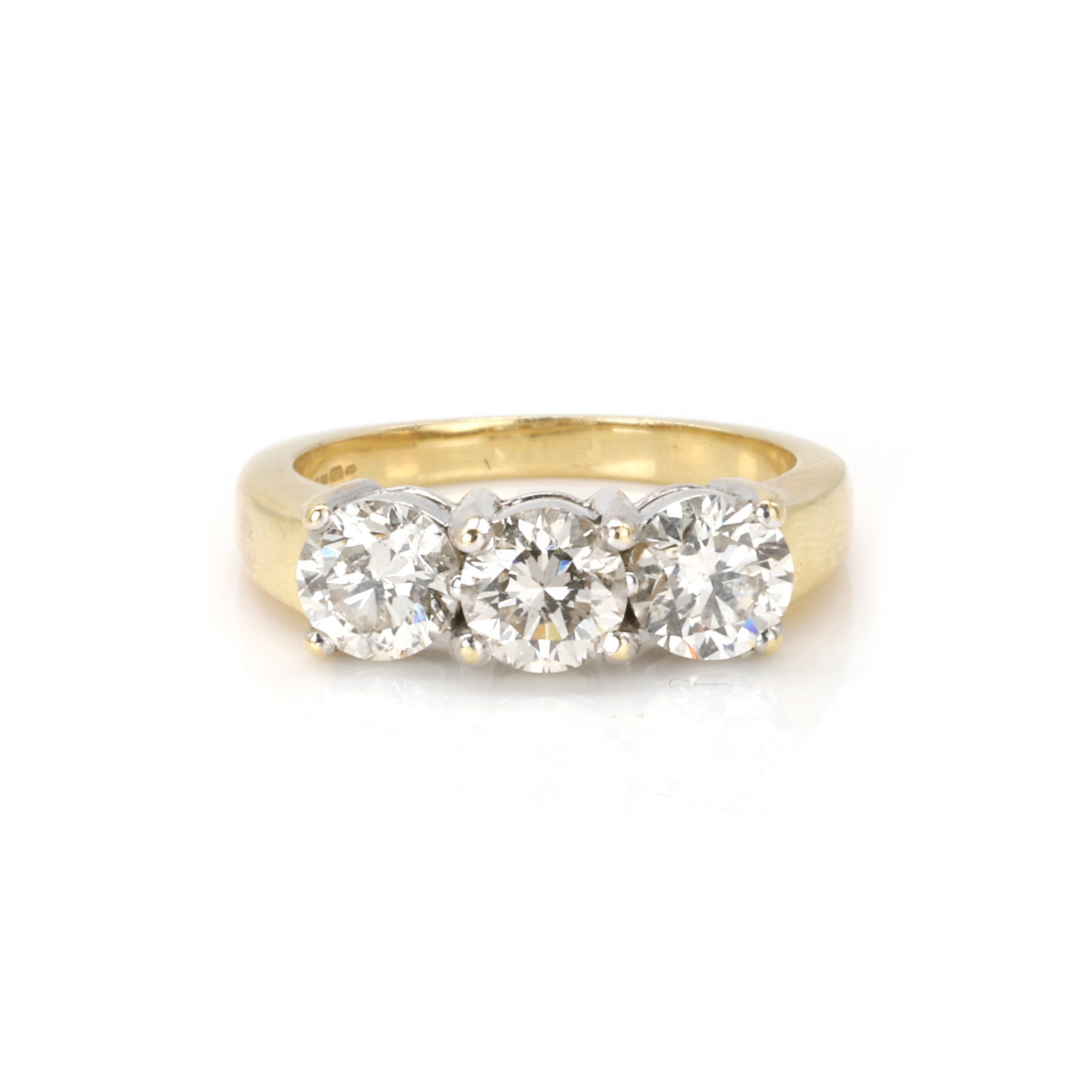 An 18ct gold diamond three stone ring, (1 of 3)