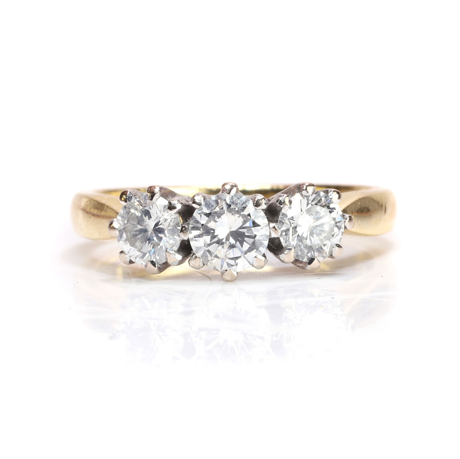 An 18ct gold diamond three stone ring, (1 of 3)