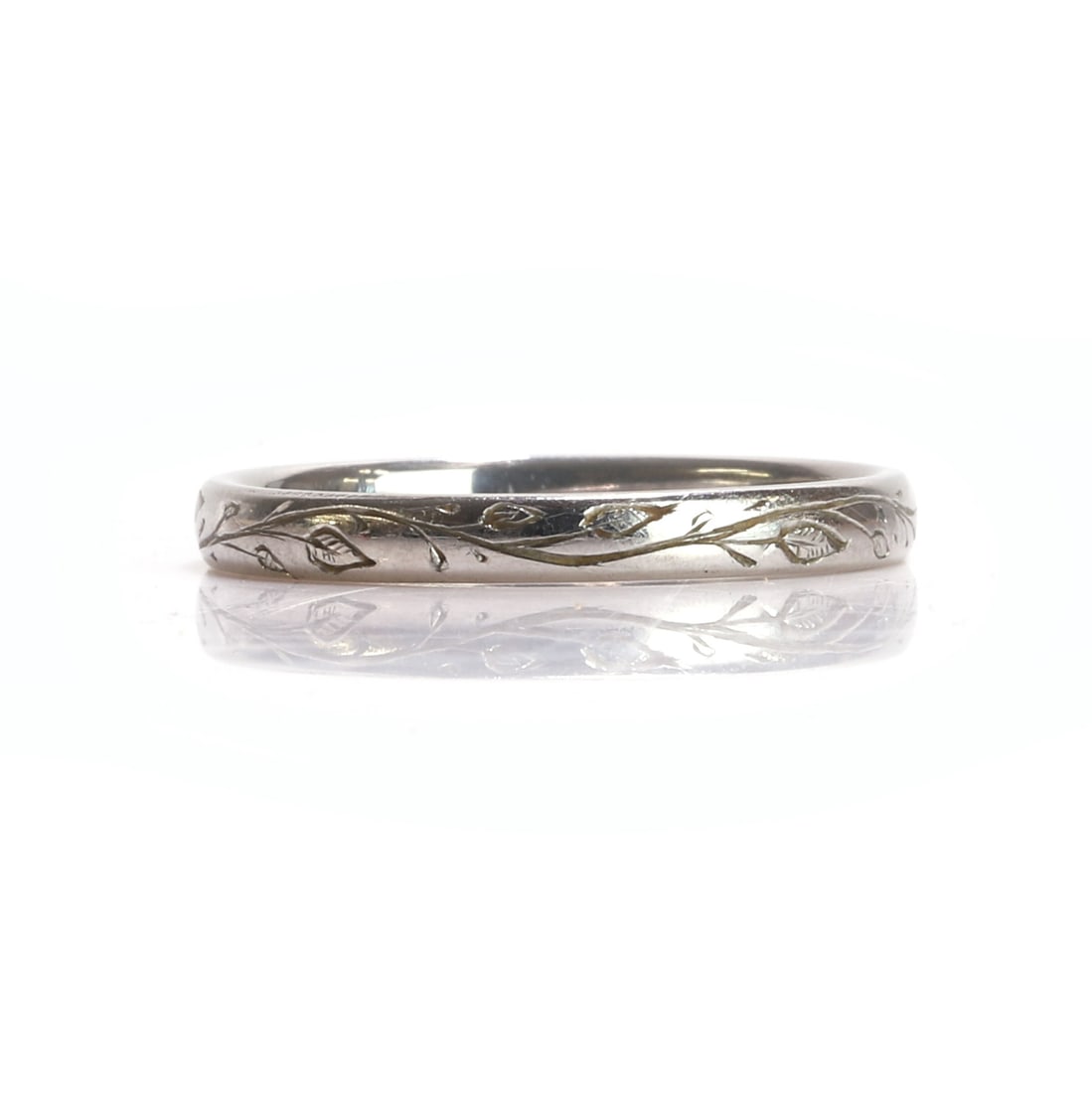 A platinum engraved wedding band, (1 of 2)
