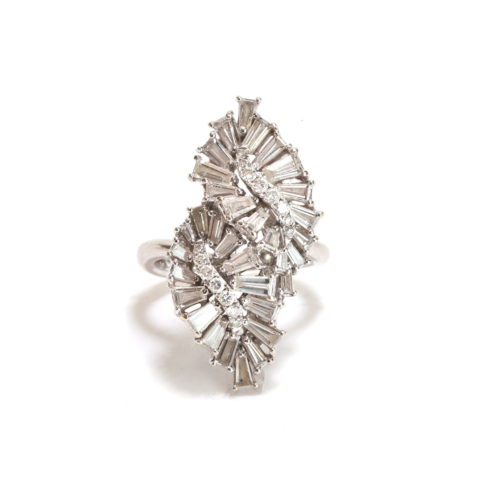 An 18ct white gold diamond cocktail ring,: An 18ct white gold diamond cocktail ring, of spray cluster design, composed of two tapered baguette diamond swirls, each centred with a line of round brilliant cut diamonds, all claw set to a wirework