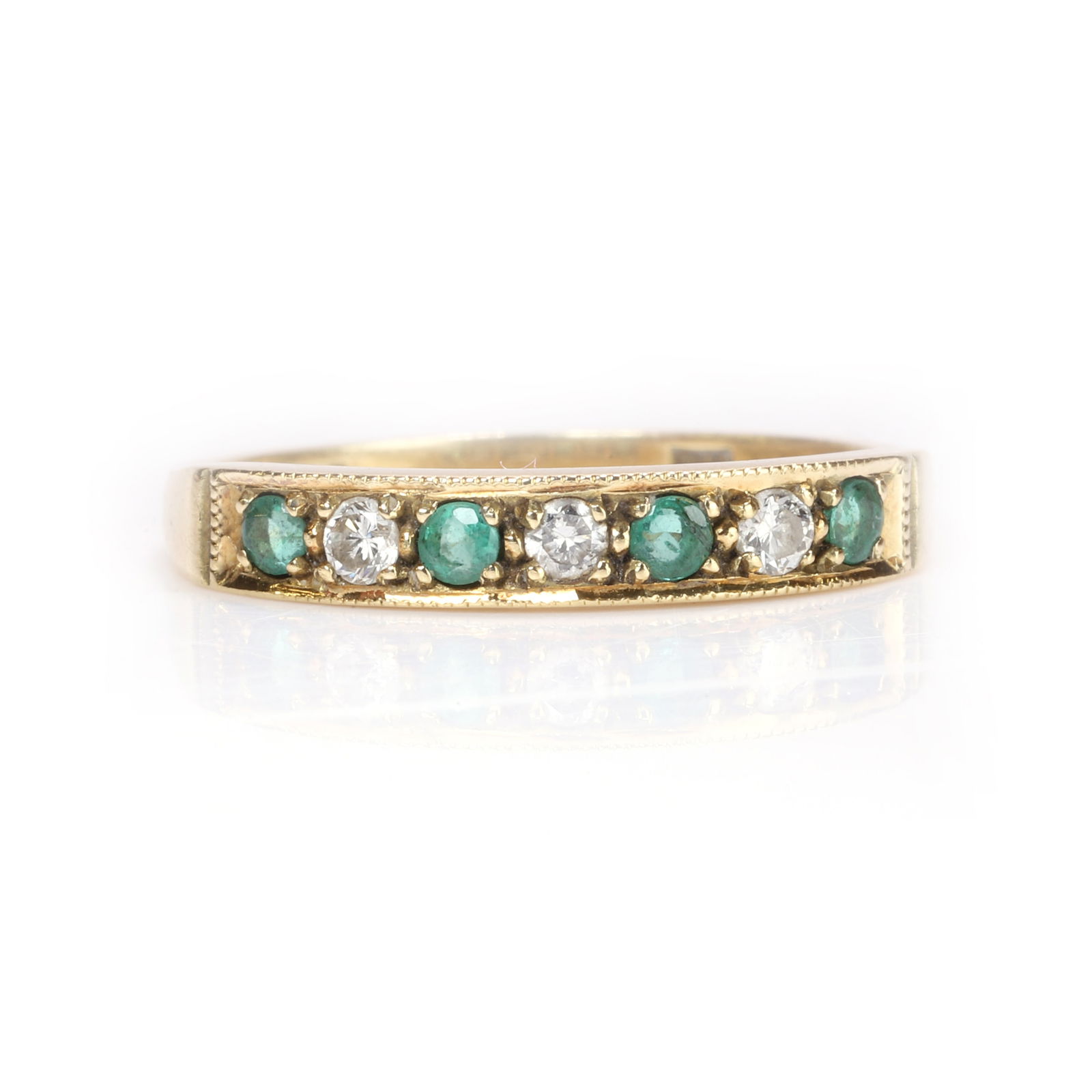 An 18ct gold emerald and diamond half eternity ring, (1 of 3)