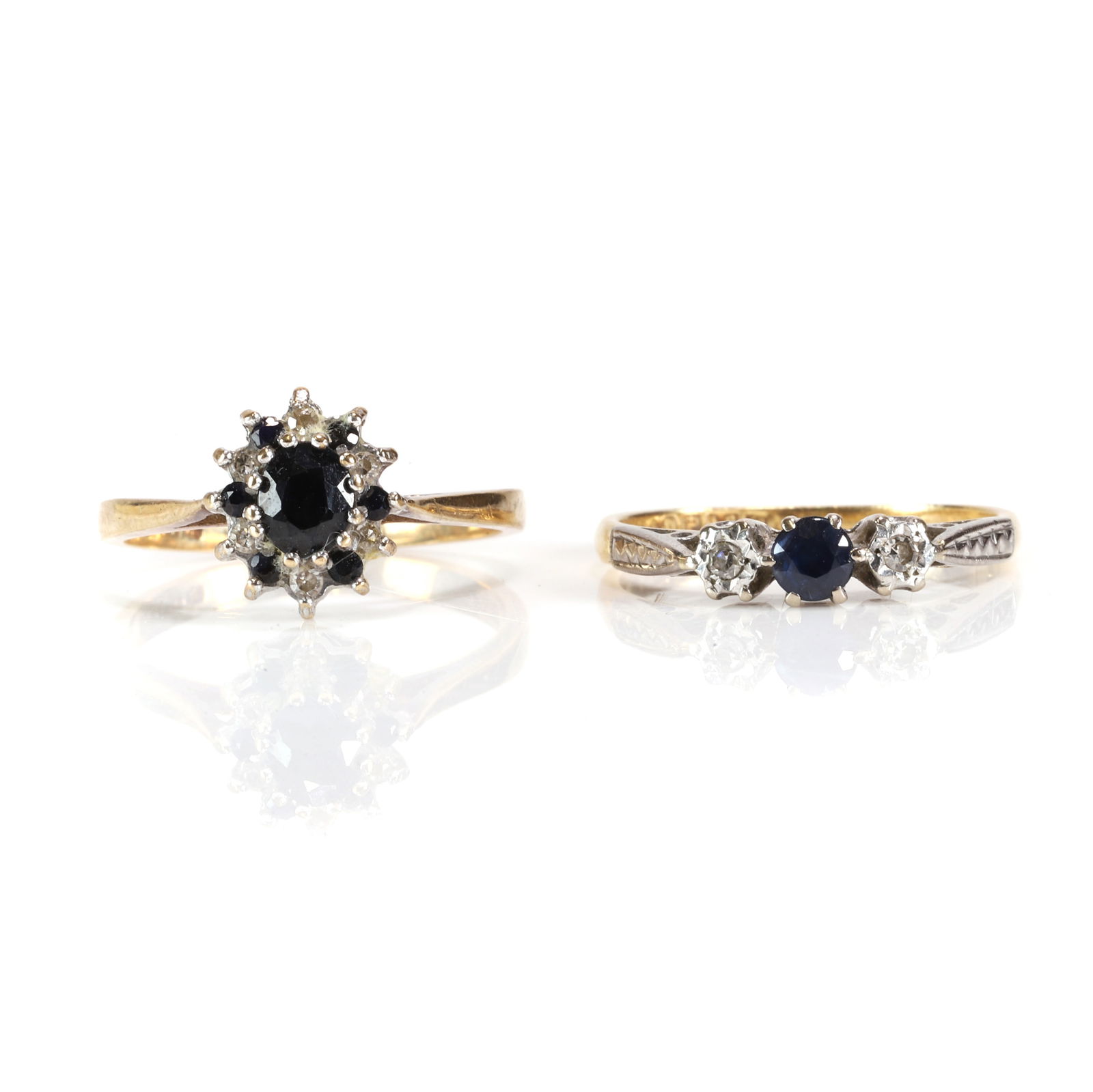 An 18ct gold sapphire and diamond three stone ring and a 9ct gold sapphire and diamond cluster ring, (1 of 3)