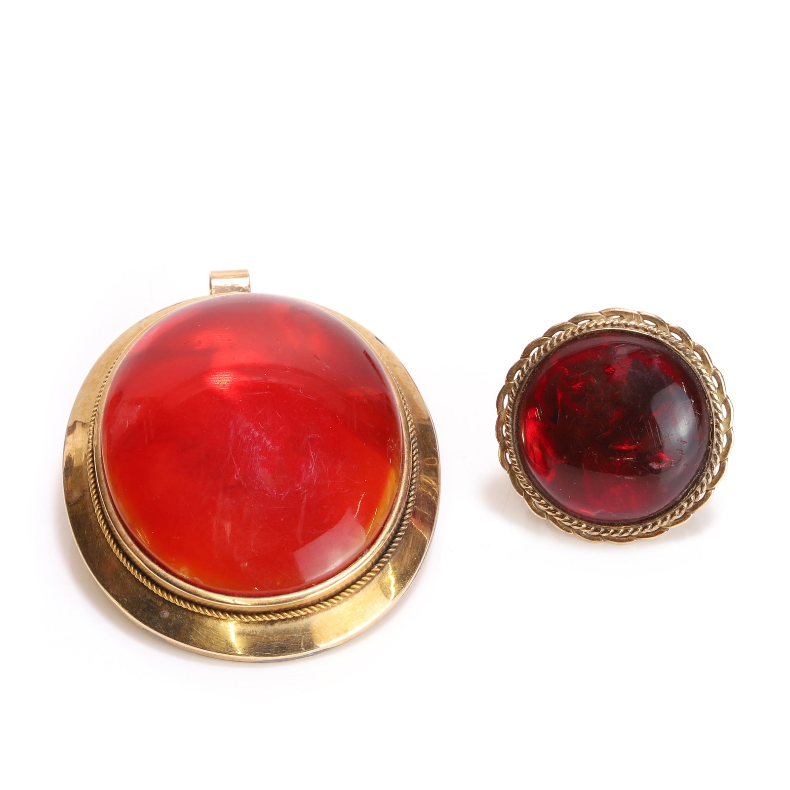 A foiled clarified amber ring and a simulated amber brooch/pendant,: A foiled clarified amber ring and a simulated amber brooch/pendant, the ring with a foiled circular clarified amber cabochon, bezel set to a wire twist surround, upon looped wire shoulders and a court