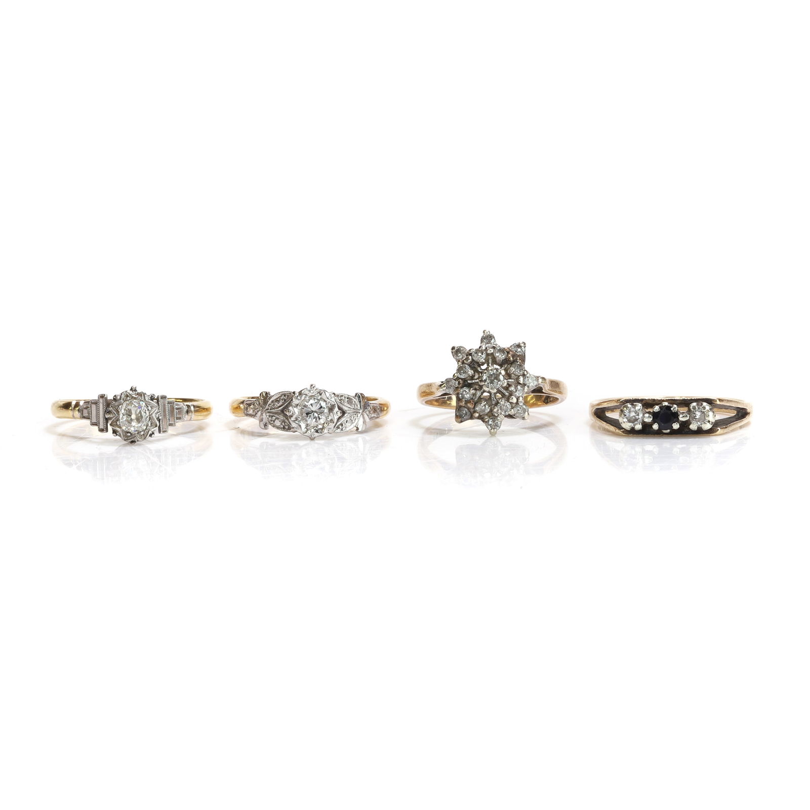 A group of four diamond and gemstone set rings, (1 of 3)