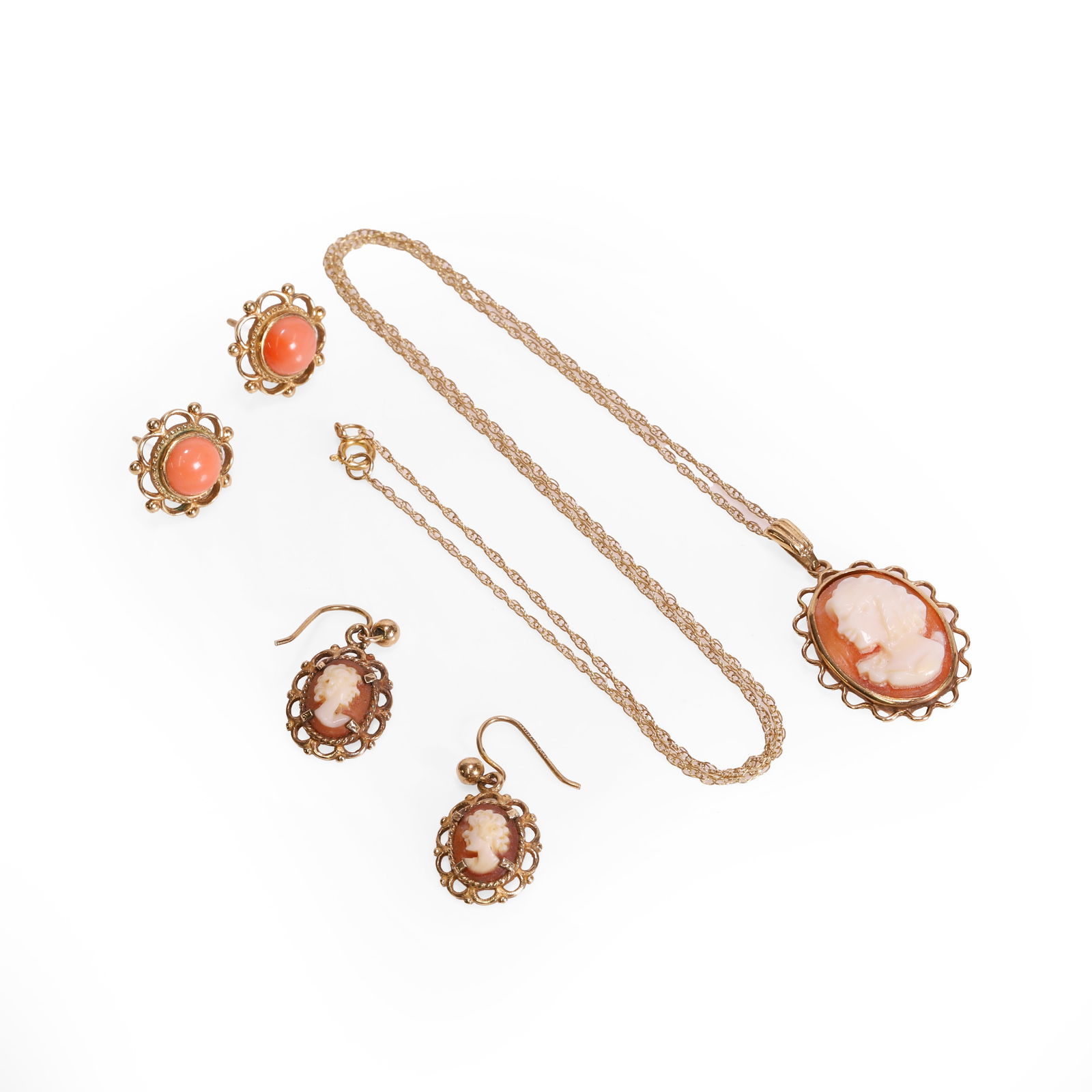 A small group of 9ct gold shell cameo and pink coral jewellery,: A small group of 9ct gold shell cameo and pink coral jewellery, comprising a 9ct gold shell cameo pendant, suspended by a Prince of Wales link chain, Birmingham 1990, a pair of similar 9ct gold shell
