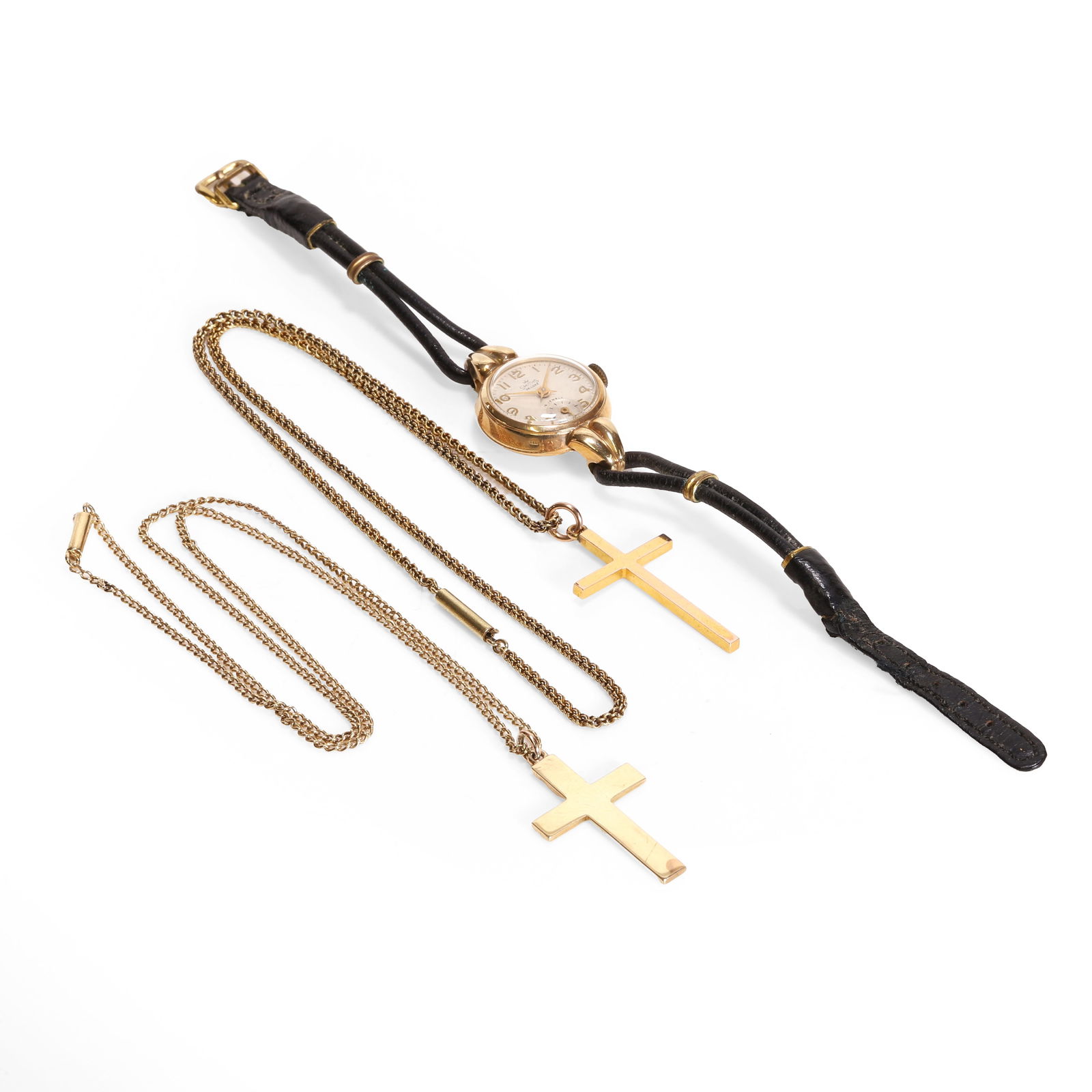 Two cross pendants and a mechanical strap watch,: Two cross pendants and a mechanical strap watch, comprising a cross pendant, suspended by a curb link chain, stamped 9ct, a 9ct gold cross pendant, hallmarked Birmingham 1906, suspended by a doubled c