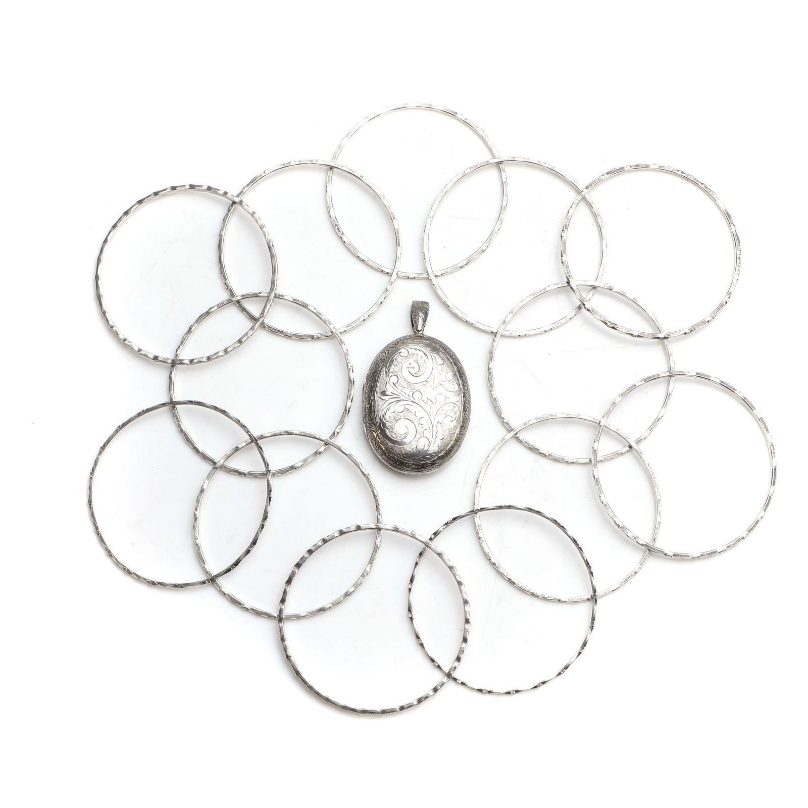 A group of silver bangles and a photo locket pendant, (1 of 2)