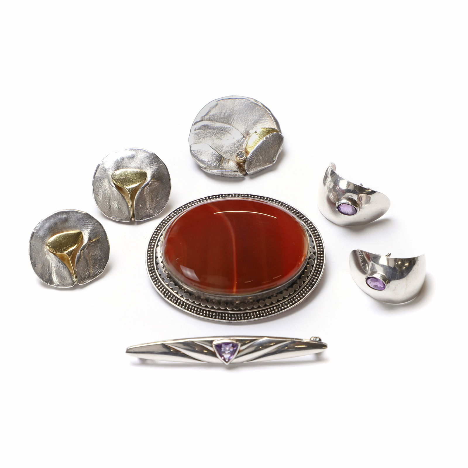 A group of silver jewellery,: A group of silver jewellery, comprising a silver diamond pendant/brooch, by Djonna Larsson, sponsor mark for Argenta Design, London import hallmark, 1985, a pair of stud earrings, by Djonna Larsson, t