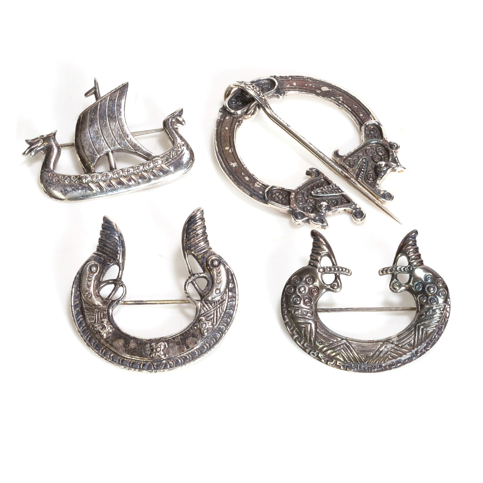 A group of silver brooches, (1 of 2)