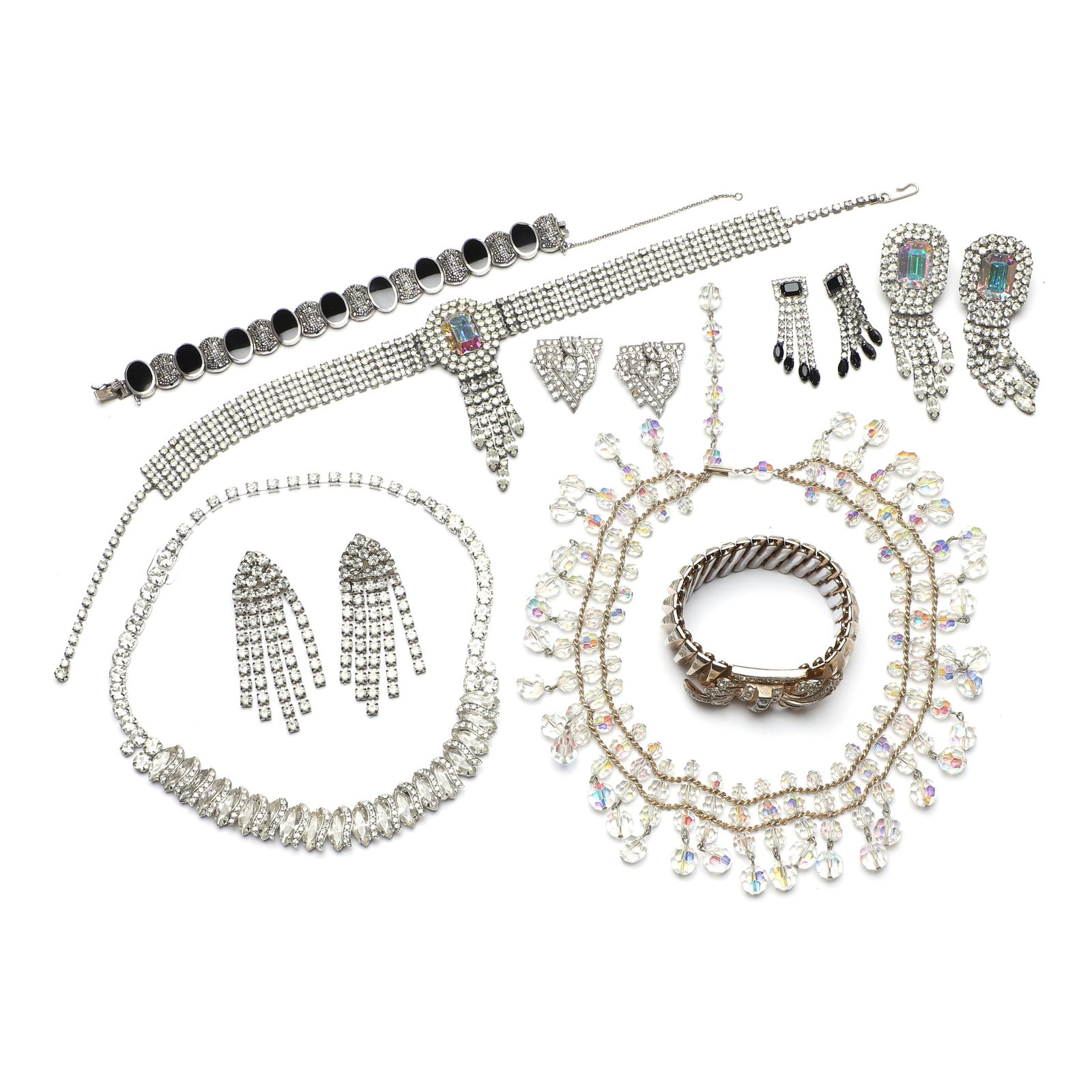 A collection of modern paste set costume jewellery,: A collection of modern paste set costume jewellery, comprising an onyx and marcasite link bracelet, tested as silver, a white metal paste necklace, a white metal paste fringe necklace, a white metal p