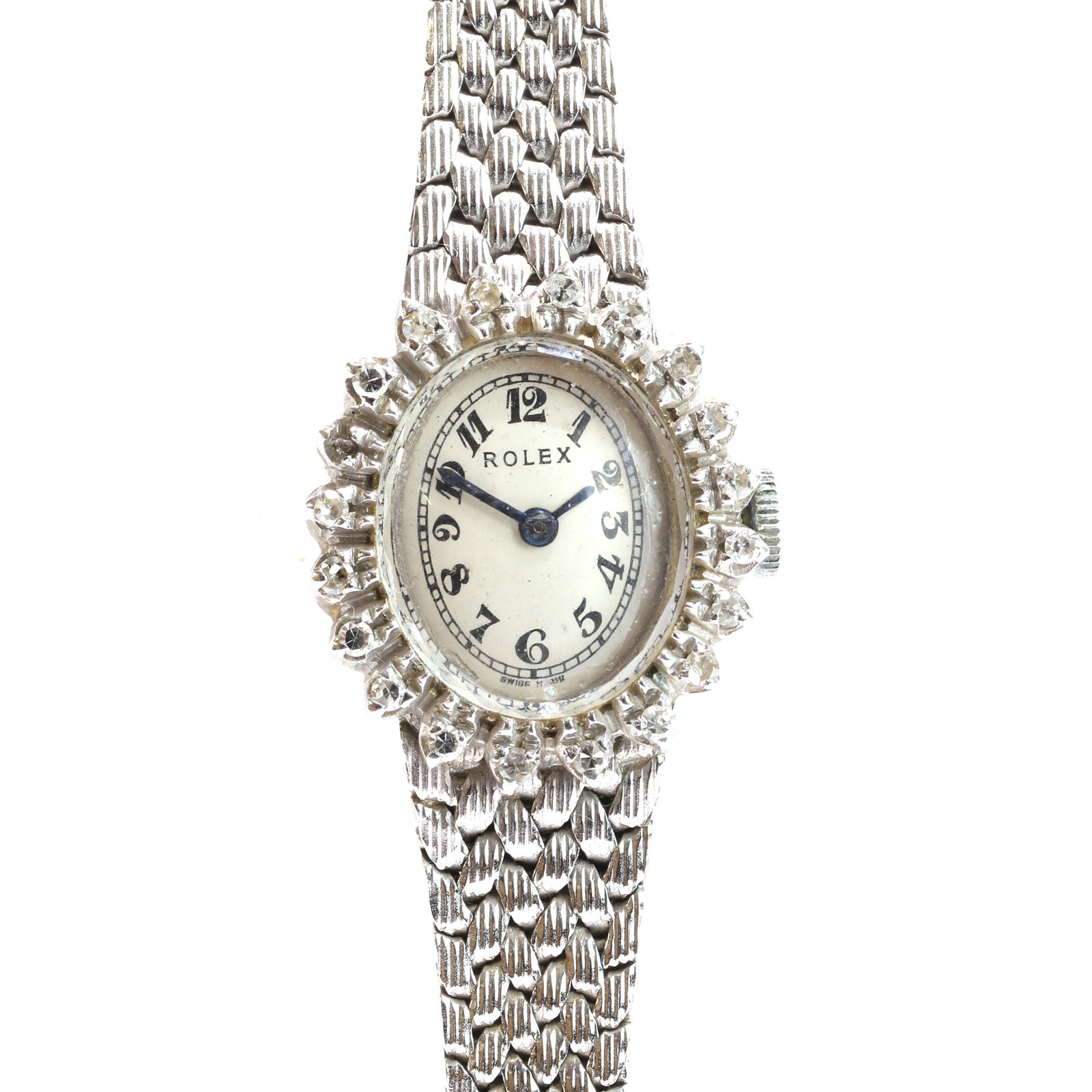 Rolex, an 18ct white gold diamond set ladies' Orchid mechanical watch,: Rolex, an 18ct white gold diamond set ladies' Orchid mechanical watch, the oval dial claw set with a line of eight cut diamonds, one diamond loose, a silvered dial, black Arabic numerals, blued sword