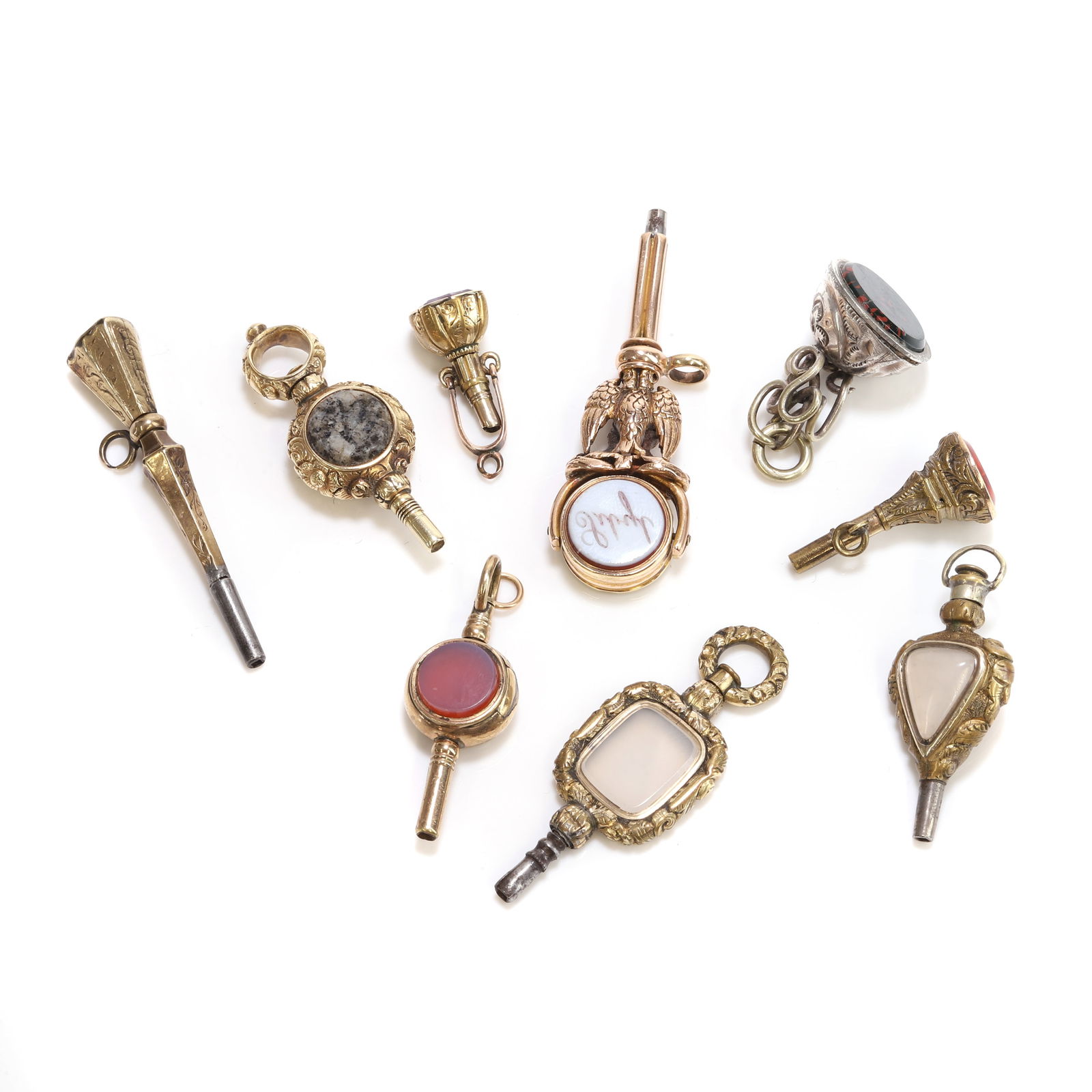 A group of nine rolled gold and gold mounted watch keys, regency and 19th century, (1 of 2)