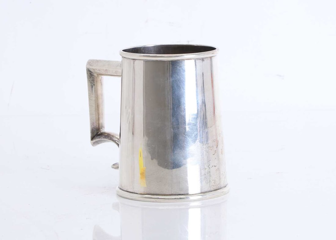 A Mexican silver tankard,: A Mexican silver tankard, of plain straight-sided form with a rolled rim, the squared loop handle, and curved lower terminal, marked sterling 925, makers marks rubbed 12cm high; 15.6ozt Condition