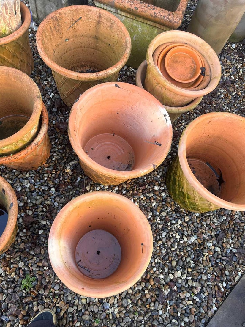 A large collection of terracotta pots, 21st century,: A large collection of terracotta pots, 21st century, decorated with low relief studded cross banding The largets 48cm diameter qty.