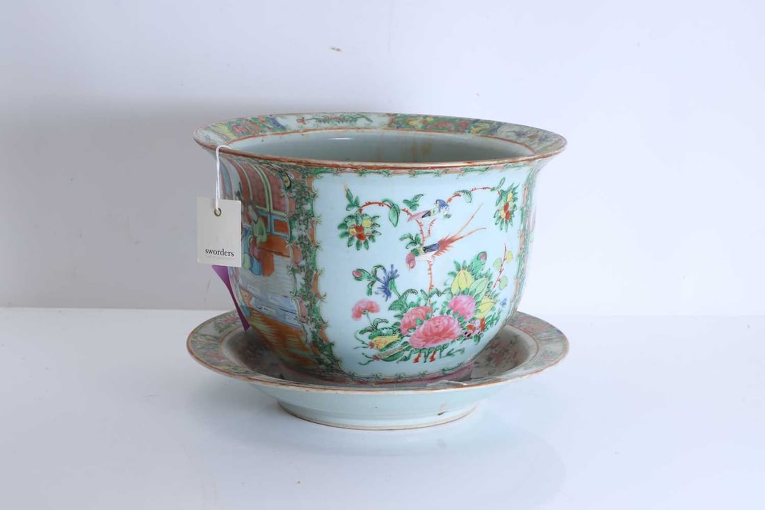 A Chinese famille rose planter, 19th century,: A Chinese famille rose planter, 19th century, decorated with prunus blooms, exotic birds, and an interior scene, together with a similar charger, with floral reserves to the rim Planter, 33cm