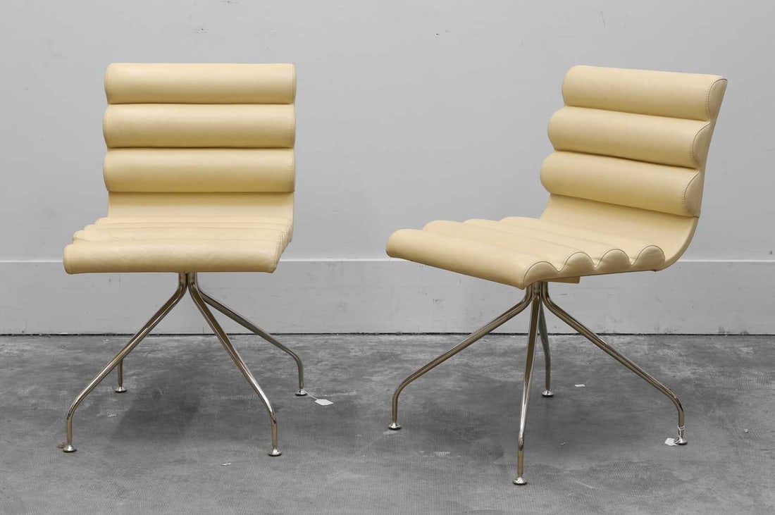 Giovanna Modonutti 'Giofra' (b.1953) for Frag, A pair of Canouan chairs,: Giovanna Modonutti 'Giofra' (b.1953) for Frag, A pair of Canouan chairs, made in italy, white leatherette, upholstered with padded base and back, on a self centering swivel base over four chrome