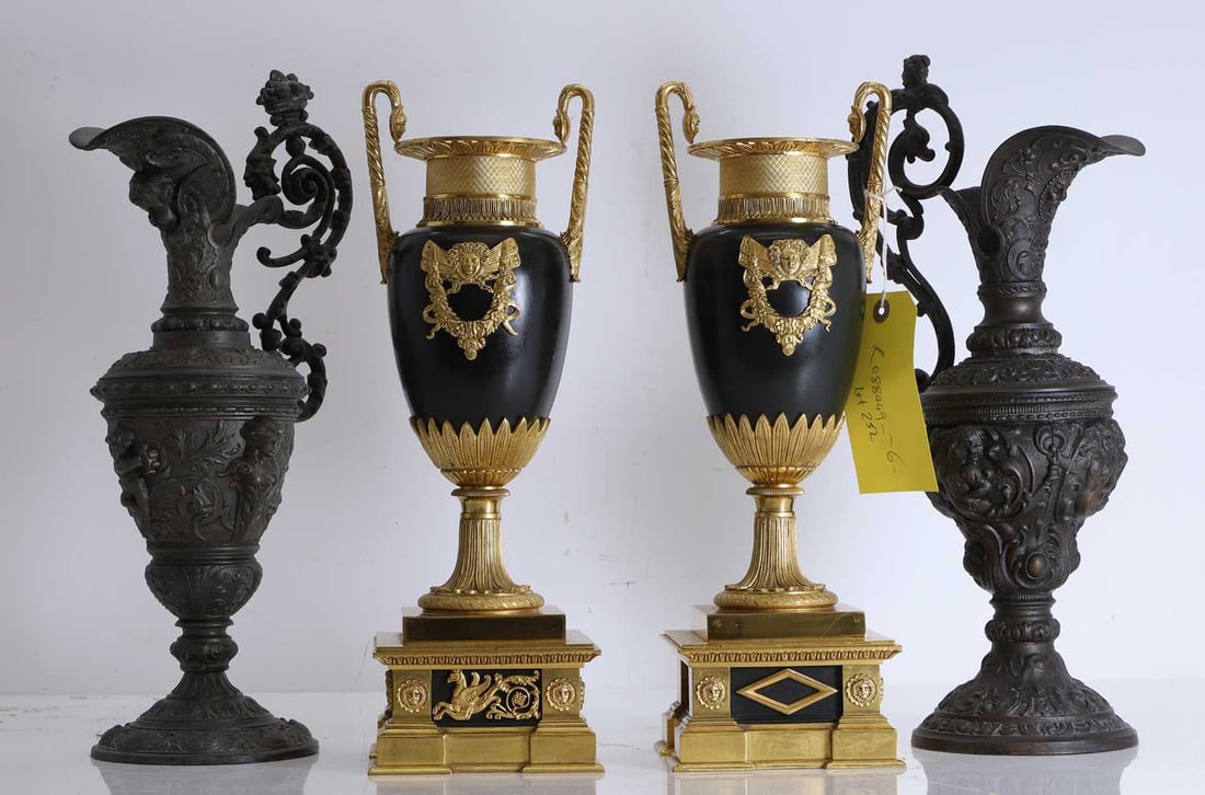 A pair of gilt bronze and patinated urns, Late 19th century,: A pair of gilt bronze and patinated urns, Late 19th century, each with neo-classical decoration, on stepped plinths, and together with a pair of modern cast ewers 39.5cm high, modern pair, 40cm