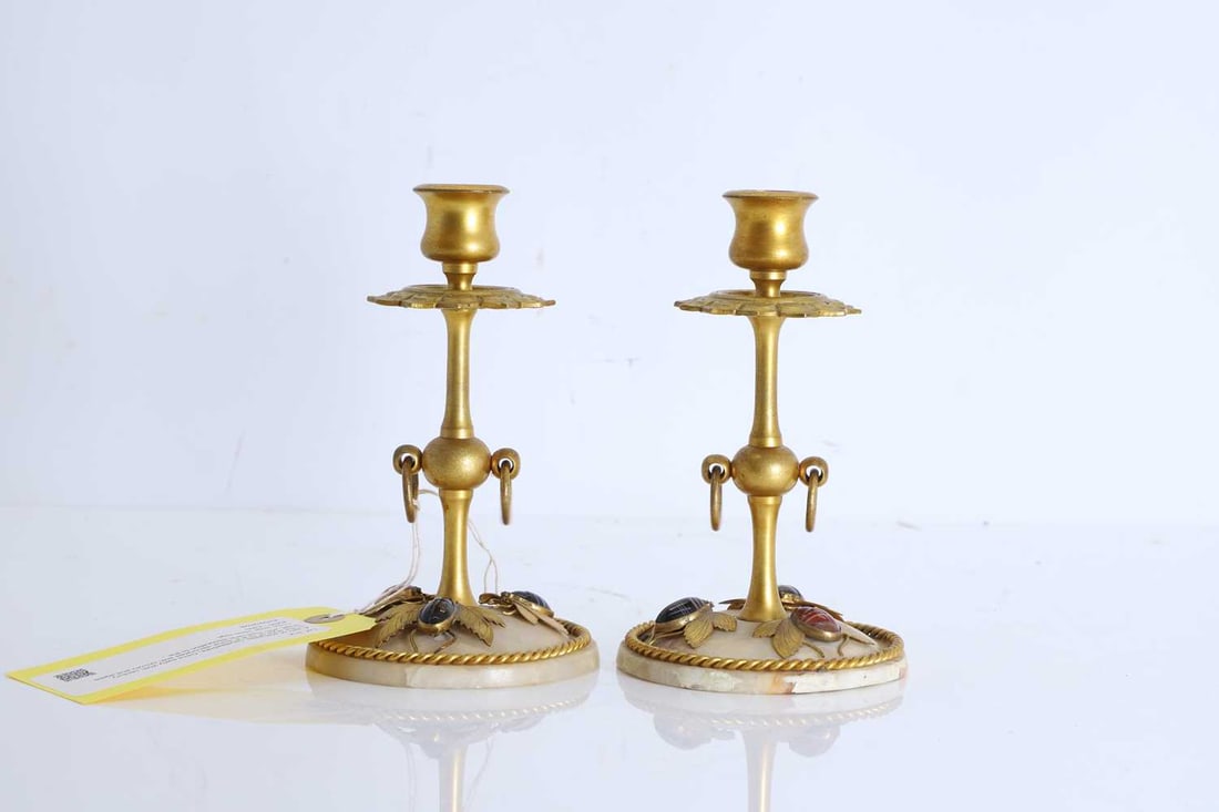 A pair of alabaster candlesticks, Circa early 20th century,: A pair of alabaster candlesticks, Circa early 20th century, in the style of 'G B & Sons' decorated with ormolu and agate bugs, with rope twist decoration to the base and a geometric floral drip