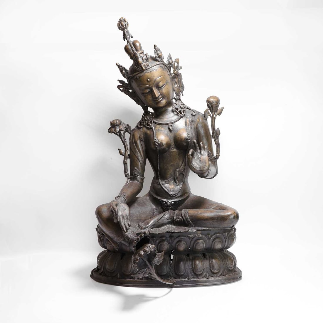 A very large Nepalese bronzed-brass figure of Tara, 20th century,: A very large Nepalese bronzed-brass figure of Tara, 20th century, seated in lalitasana on a double lotus dais throne 87cm high
