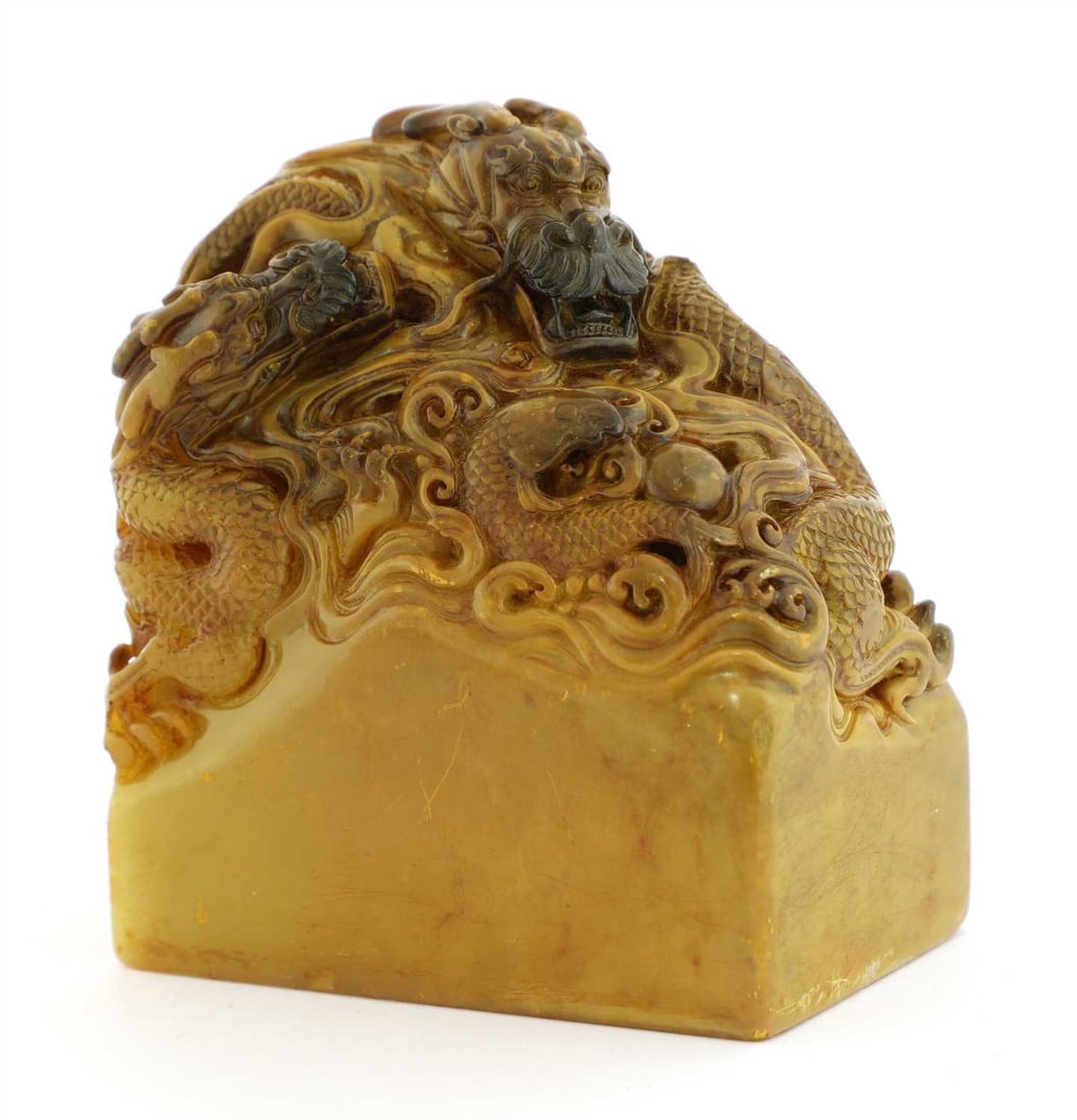 A Chinese soapstone seal,: A Chinese soapstone seal, of rectangular form, surmounted by two dragons chasing a flaming pearl and a carp amongst the spuming waves, the seal face carved with 'Da Ming Yuan Jing Yin Kong Kuang', &#