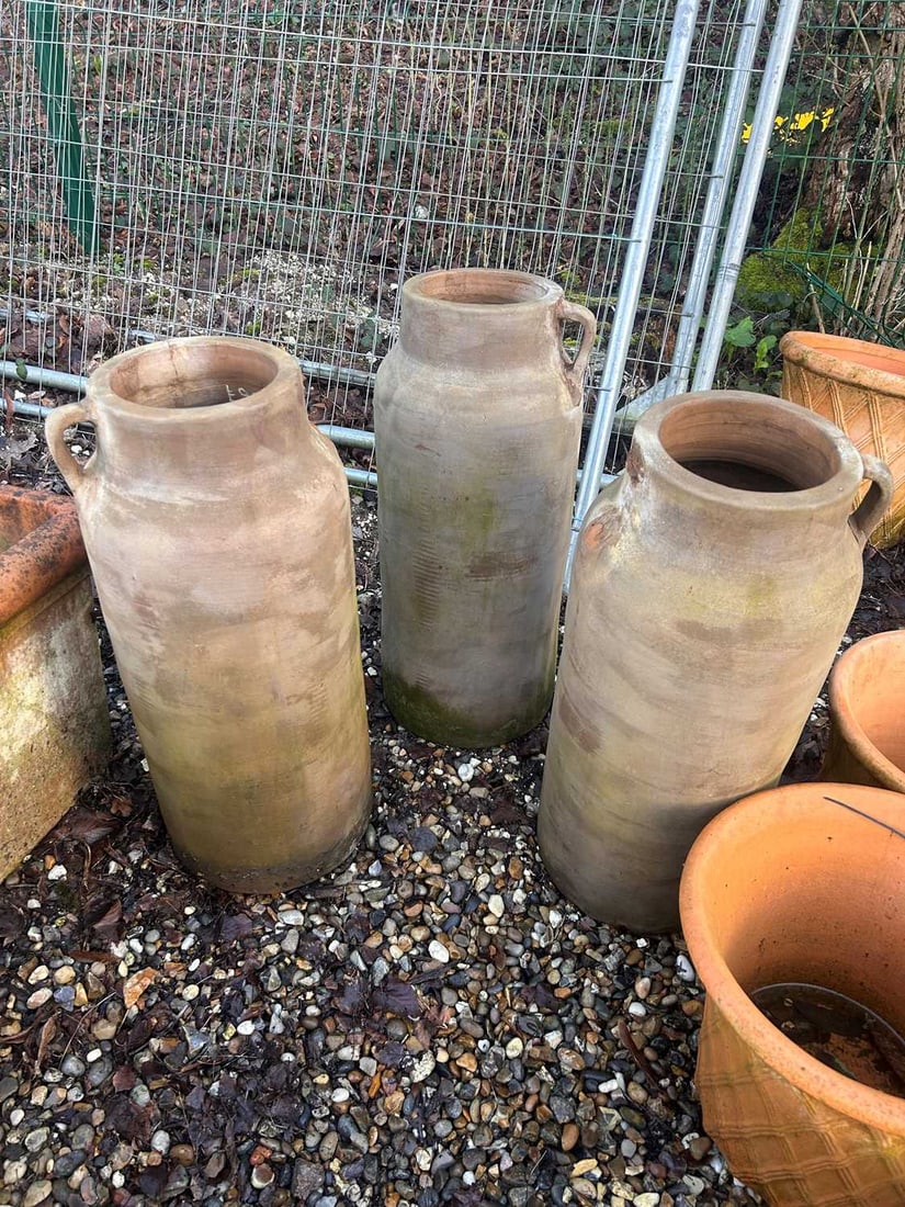 Three pottery olive oil jars, Of modern manufacture,: Three pottery olive oil jars, Of modern manufacture, of elongated form and side handles 30cm wide, 68cm high 3 Condition Report: The handles on most broken off