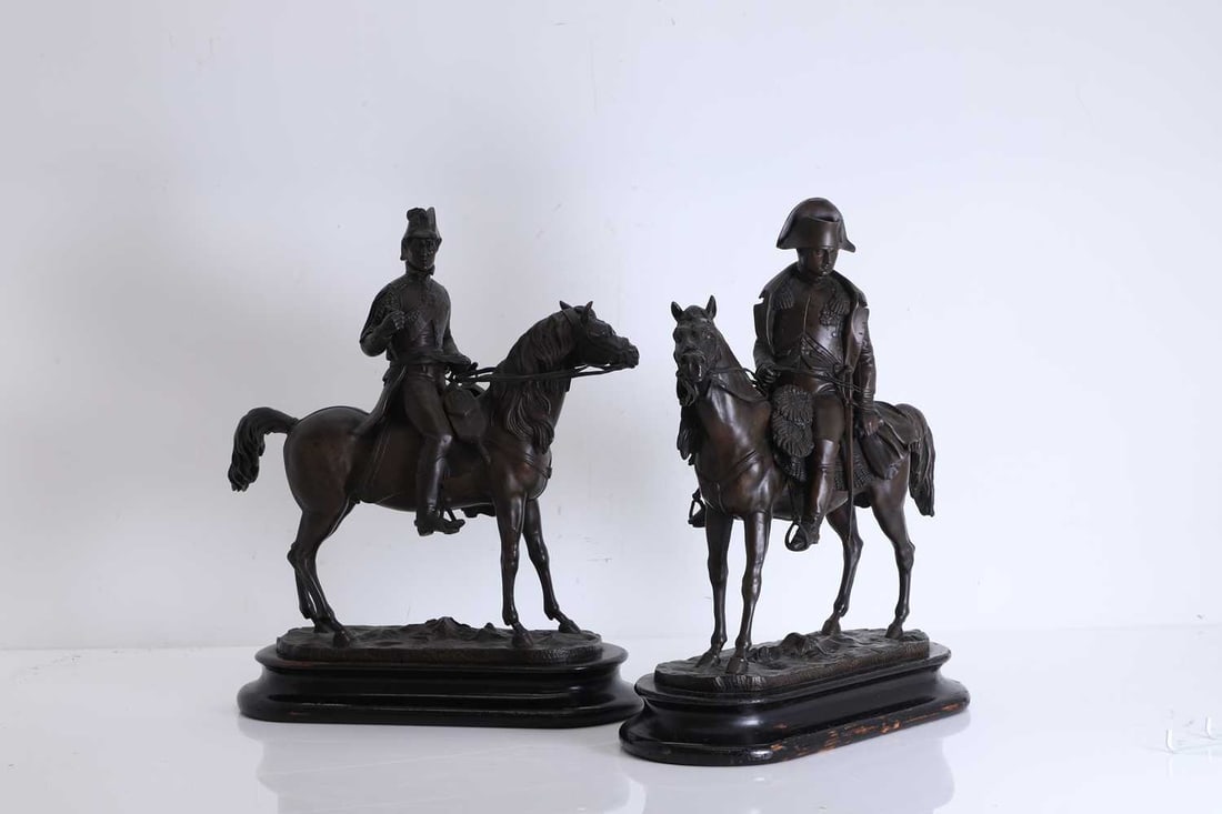 A pair of figures of Napoleon and Wellington, Modern,: A pair of figures of Napoleon and Wellington, Modern, each bronzed, mounted on a horse, raised on ebonised plinths 40cm high 2 Condition Report: Modern, filled sculptures, flaking to the bases.