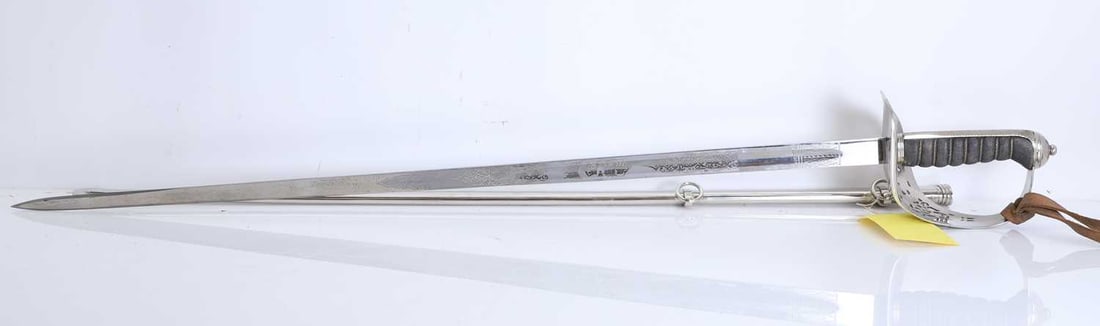 An Edward VII Royal Engineers officers dress sword, 20th century,: An Edward VII Royal Engineers officers dress sword, 20th century, with a wired shagreen handle, with an etched blade, in a metal scabbard, and leather cover, impressed 'BH', together with another
