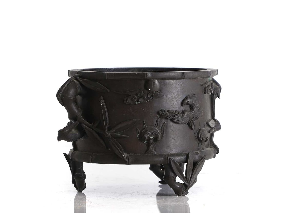 A bronze censor or jardinière, 20th century, Chinese,: A bronze censor or jardinière, 20th century, Chinese, the decoration cast in relief with a crane, phoenix, lingzhi, bamboo amongst clouds, the feet and handles cast naturalistically as bamboo, w