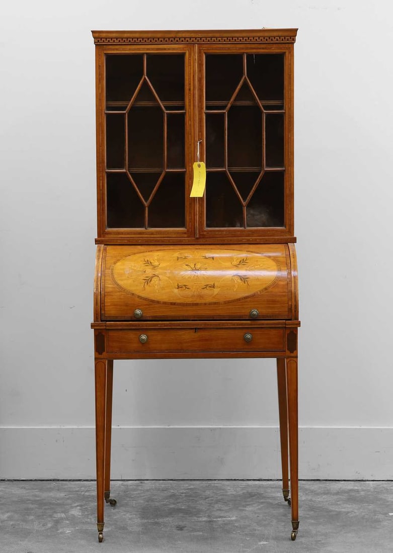An Edwardian satinwood inlaid cylinder bureau bookcase, 20th century,: An Edwardian satinwood inlaid cylinder bureau bookcase, 20th century, of small proportions, the glazed top, enclosing two shelves, over the cylinder front with a marquetry panel, opening to reveal
