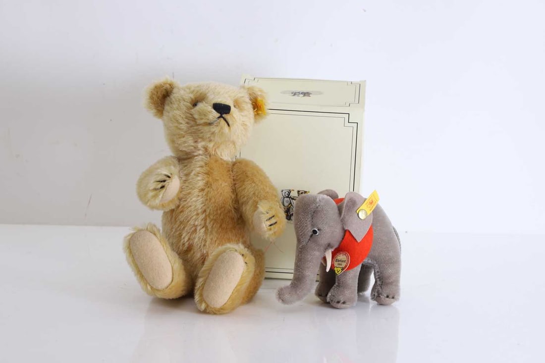 A pair of Steiff stuffed animals,: A pair of Steiff stuffed animals, To include a Steiff Bear, 660191, with pin to the ear, and a Steiff Elephant, 031137, with original box Bear, 20cm high; Elephant, 12cm wide 2
