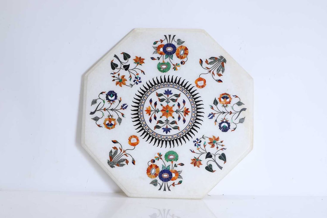 An Agra octagonal marble pietra dura table top, Indian, 1979,: An Agra octagonal marble pietra dura table top, Indian, 1979, the white marble top of octagonal form, with moulded edge, inlaid with polychrome hardstone, including Sodalite, Cornelian, Jasper,