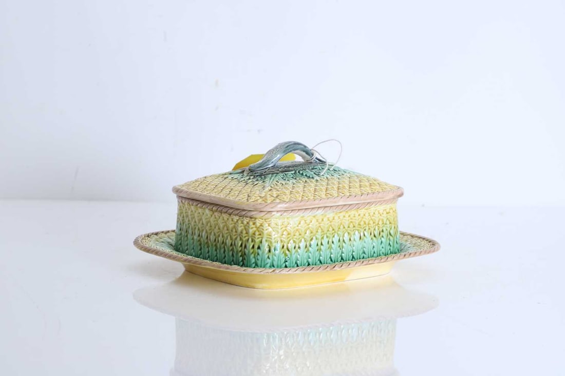 A Majolica pineapple sardine box and cover, Circa late 19th century,: A Majolica pineapple sardine box and cover, Circa late 19th century, the lid featuring three fish laying on the pineapple pattern ground, one modelled as a handle , with rope twist border to dish and