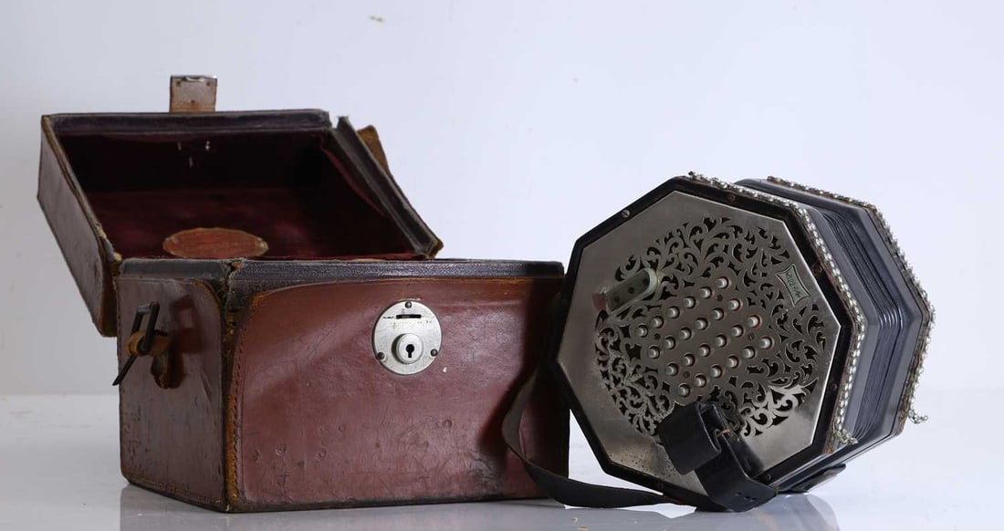 G Wheatstone & Co, c.1929, a forty-nine button concertina,: G Wheatstone & Co, c.1929, a forty-nine button concertina, no. 32264, chrome buttons and sound frets with leather straps, in a leather case, labelled 17cm wide 2 Condition Report: Leather case