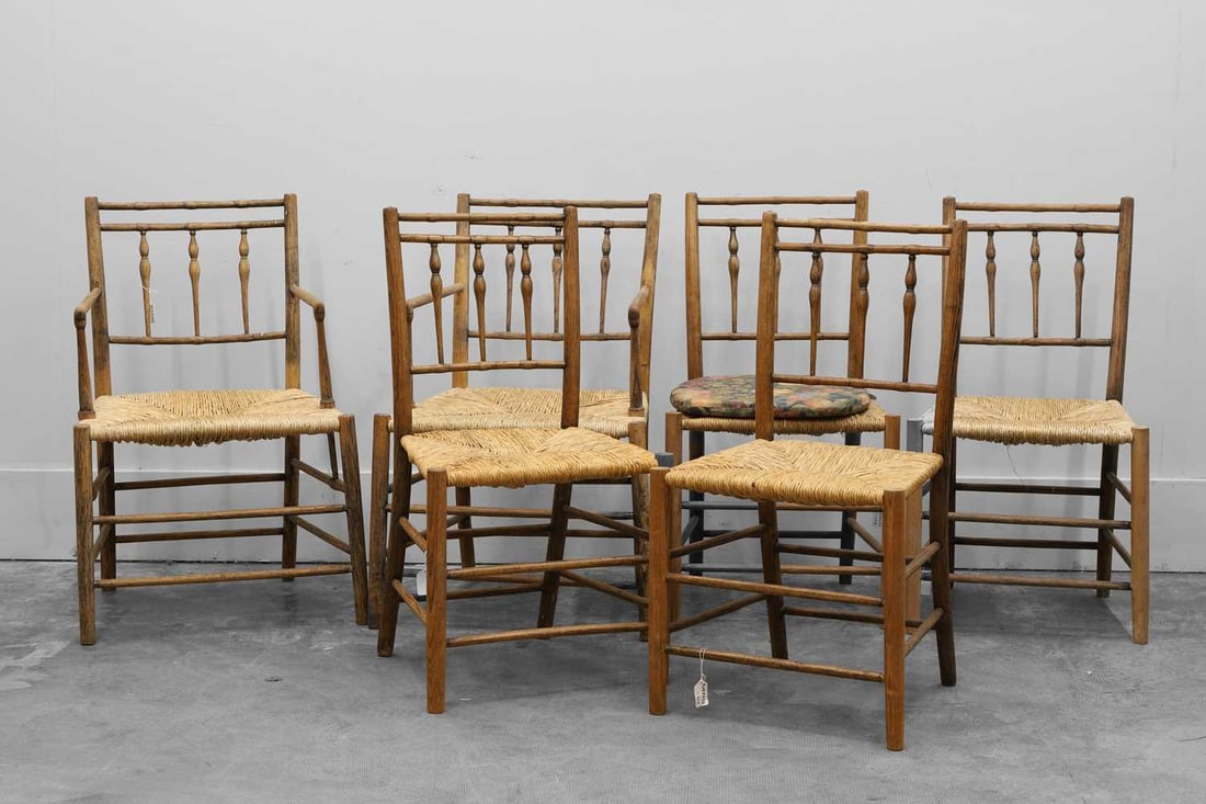 A set of four plus two ash and beech Sussex chairs, Early 20th century,: A set of four plus two ash and beech Sussex chairs, Early 20th century, with woven straw seats and turned three-column back splats Carvers, 55cm wide, 45cm deep, 86cm high; Chair, 47cm wide, 38cm