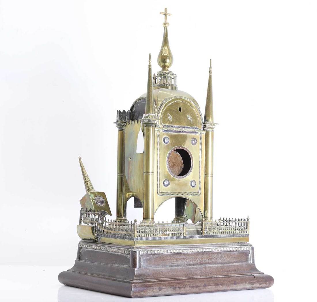A Victorian architectural brass table clock case, Late 19th century, Gothic revival,: A Victorian architectural brass table clock case, Late 19th century, Gothic revival, in the Elizabethan style, the case concieved as a miniature ecclestsiastical edifice with central domed chamber