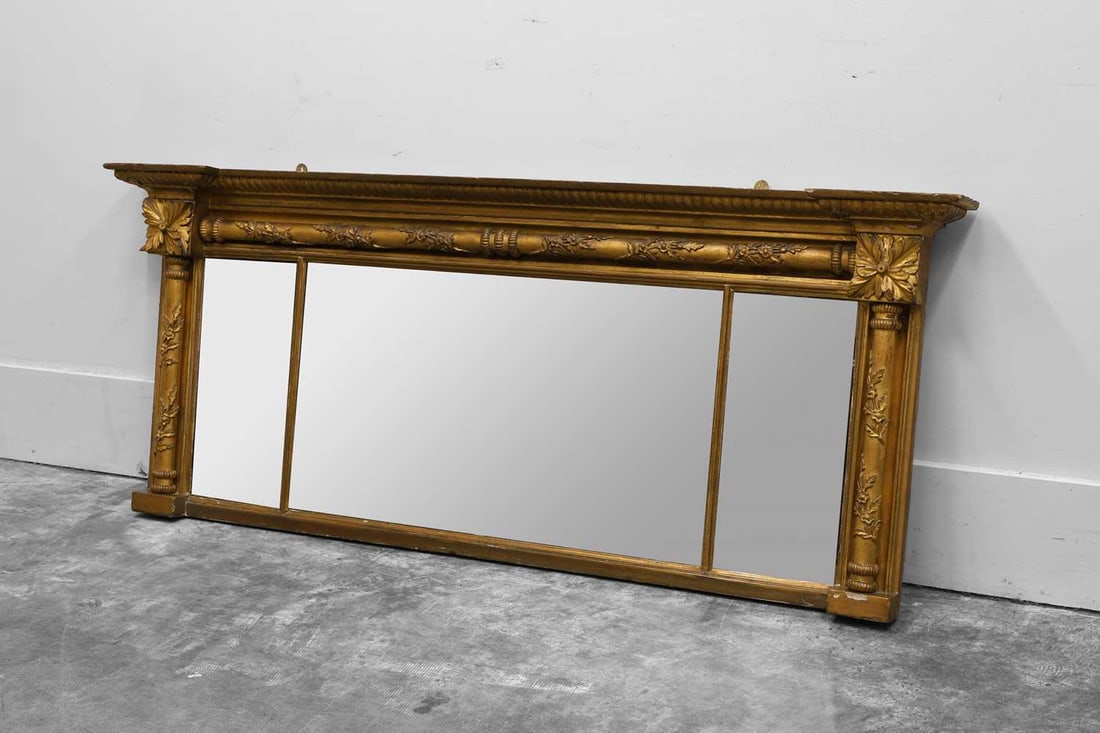 A Regency giltwood overmantel mirror, 19th century,: A Regency giltwood overmantel mirror, 19th century, the columned border detailed with twisting foliage surrounding a triple plate 163.5cm wide, 71cm high