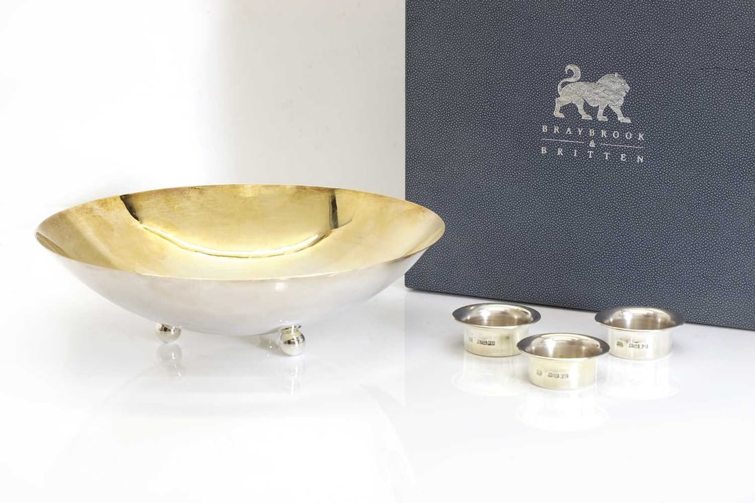 A modern silver bowl,: A modern silver bowl, by Braybrook & Britten, Birmingham, 2001, the gilt shallow bowl, raised on three ball feet, with three further silver 'floats' 25.5cm diameter, 16.9ozt Condition Report: