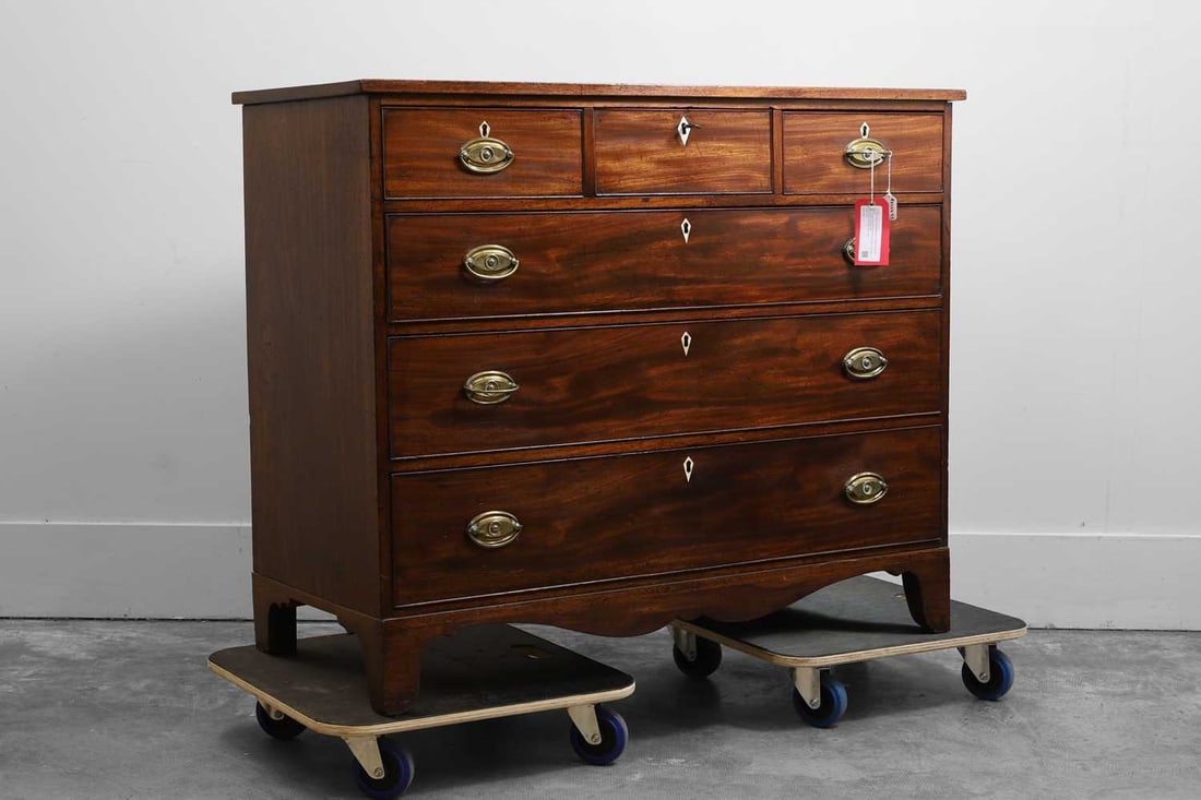 A Scottish George III mahogany chest of drawers, Late 18th century,: A Scottish George III mahogany chest of drawers, Late 18th century, the rectangular top above three short and three long drawers fitted with brass handles and ivory escutcheons on bracket feet Ivory