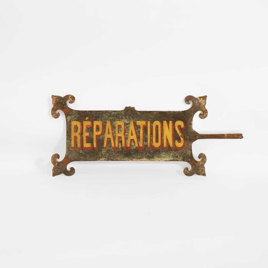 A painted metal tailors sign for “réparations” circa 1900, French: A painted metal tailors sign for “réparations” circa 1900, French of horizontal rectangular form with scrolling foliate terminals to each corner, mounted with a projecting bracket fo