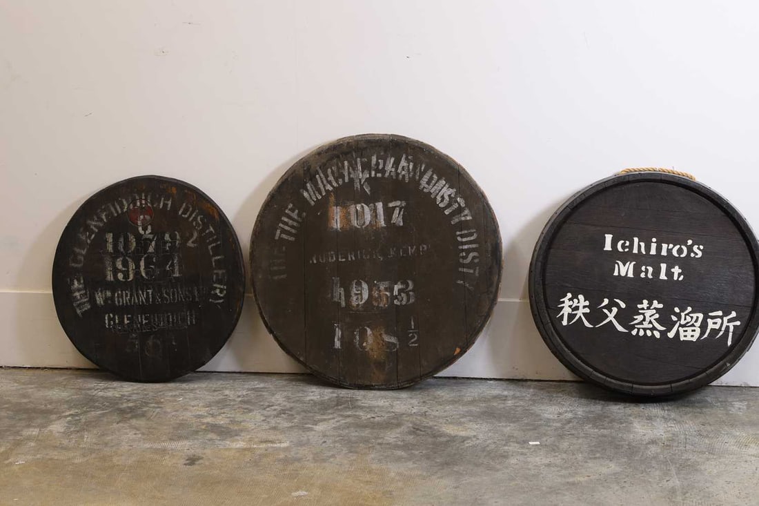 A group of three whisky barrel tops, 20th century,: A group of three whisky barrel tops, 20th century, inscribed 'THE GLENFIDDICH DISTILLERY', 'ICHIRO'S MALT', and third one that has been overprinted The largest, 66cm diameter 3