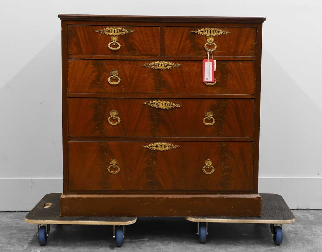 A flame mahogany chest of drawers, 20th century,: A flame mahogany chest of drawers, 20th century, with gilt empire style ring pull handles and escutcheons, two short drawers over three longer drawers, the top right hand drawer stamped with 'Bertram