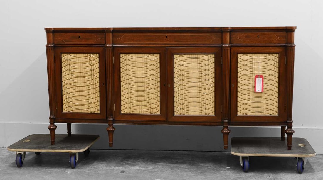 A Regency style side cabinet, 20th century,: A Regency style side cabinet, 20th century, the breakfront rectangular top with rounded projections above engaged reeded columns, the frieze inlaid with stylised line ornament and centred by a small