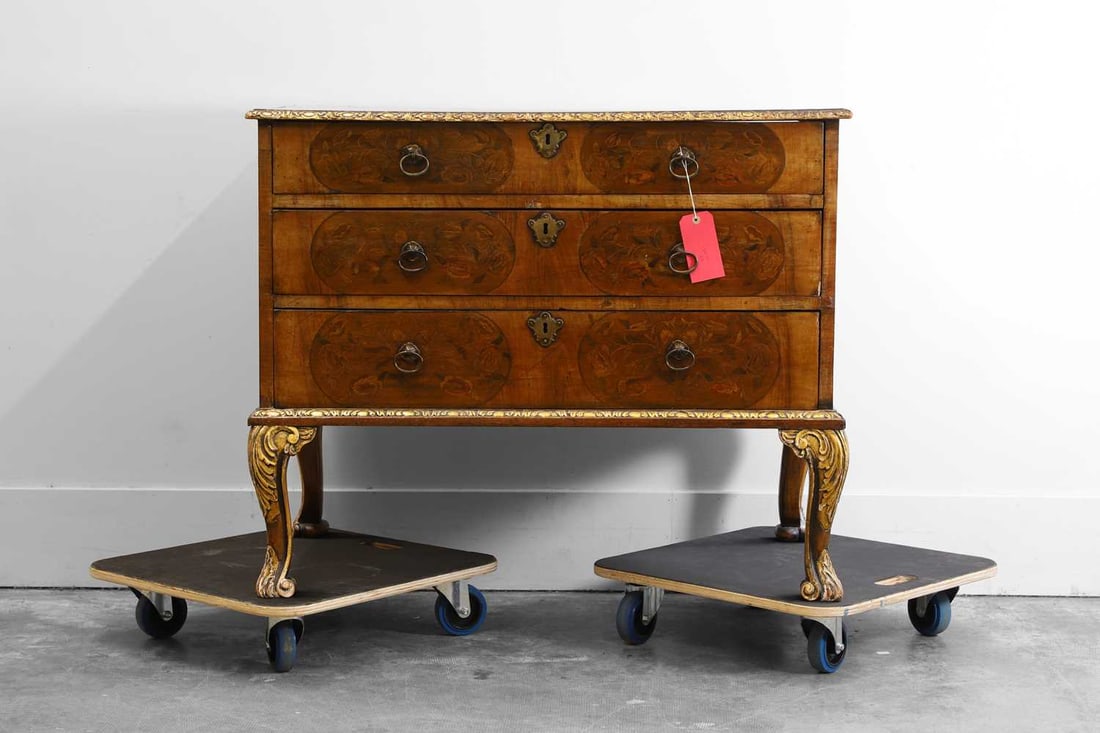 A walnut and parcel-gilt chest of drawers, late 19th/ early 20th century, (1 of 2)